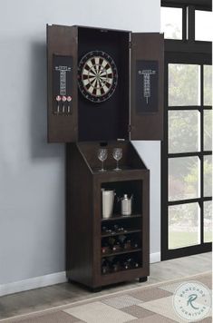 a dart cabinet with darts in it next to a vase filled with cups and glasses