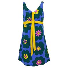 Chic 60s linen flower print sleeveless A-Line dress! Features a purple background, with pink, yellow and green flowers printed throughout. Tailored bodice with a flared skirt. Attached marigold tie detail at waist. Full metal zipper up the back with hook-and-eye closure. Buttons at each top shoulder to adjust size / height. Great with sandals, flats, wedge, boots or heels. In great condition. Approximately Size Medium Measurements: 34-36 inch bust 28-29 inch waist 38 inch hips 35 inches from top back shoulder seam to hem 1960s Fashion Dress, Yellow And Green Flowers, Linen Flower, 1960 Fashion, Floral Playsuit, 60s And 70s Fashion, Flower Purple, Pink Green Yellow, Cocktail Dress Vintage