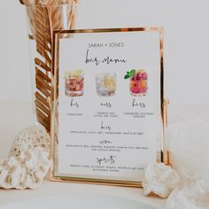 a menu with different types of desserts on it next to a vase filled with flowers