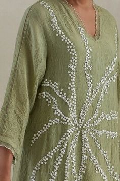 Green kaftan hand embroidered with flower motif, asymmetric hem and sheer scalloped border detailing on neck and cuffs. Paired with a flared pant with sheer border on hem and contrasting line on sides. - Aza Fashions Festive Summer Kurta With Embroidered Hem, Elegant Straight Kurta Kaftan For Summer, Spring Embellished Long Sleeve Kurta, Elegant Embroidered Neckline Tunic For Summer, Spring Embellished Tunic Kaftan, Elegant Summer Tunic With Embroidered Neckline, Elegant Spring Tunic With Embroidered Neckline, Elegant Embellished Kurta For Summer, Elegant Embellished Summer Kurta