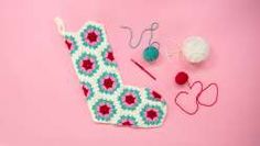 crochet items laid out on a pink surface