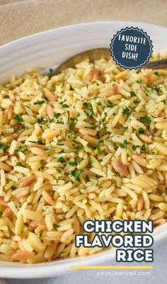 chicken flavored rice with parsley in a white bowl on top of a table