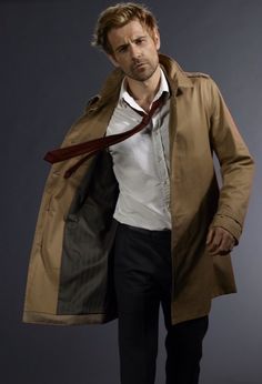 a man wearing a trench coat and tie