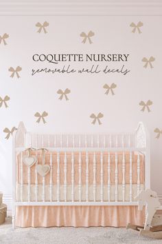 a baby's room with a crib and wall decal that says coquette nursery