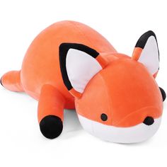 an orange and white stuffed animal laying on top of it's back with its eyes closed