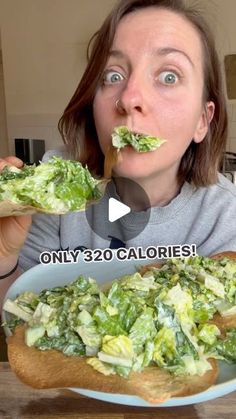 a woman is eating some food with her mouth wide open and looking at the camera