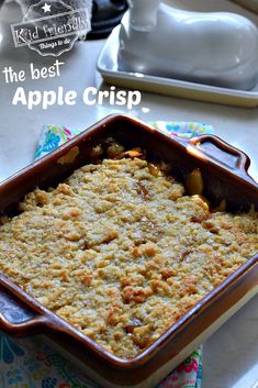 a casserole dish filled with apple crumbles on top of a table