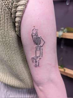 a person with a skeleton tattoo on their arm