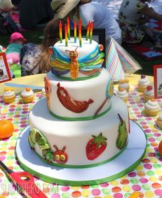 a three tiered cake sitting on top of a table