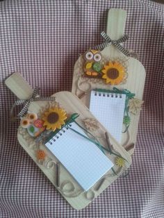 two wooden tags decorated with sunflowers and paper on a plaid tablecloth background