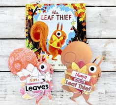 two children's books are sitting on a white wooden surface, one has an image of a squirrel and the other is a leaf thief