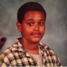 a young boy is posing for a photo