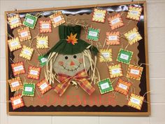 a bulletin board with a scarecrow and lots of notes attached to it that say november