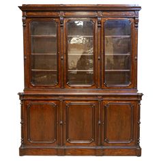 A French Louis-Philippe walnut two-part bookcase from the 19th century with blown glass doors and three wooden doors. Created in France during the mid-19th century under the reign of King Louis-Philippe, this walnut two-part bookcase epitomizes elegance and refined craftsmanship. The upper section, narrower in depth, features three doors adorned with very pretty and authentic wavy blown glass panels. These doors open to reveal spacious inner shelves, perfect for displaying books or cherished collectibles. The doors are separated by narrow vertical cartouches, reminiscent of pilasters, each topped with delicate acanthus leaf clasps, adding a touch of classical sophistication to the piece. The lower section, deeper and more robust, showcases three wooden doors with molded accents, that provi Displaying Books, Louis Philippe, Acanthus Leaf, Glass Doors, Belleza Natural, French Design, Wooden Doors, Functional Design, Glass Panels