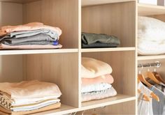 an organized closet with folded clothes on shelves