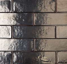 a close up view of a brick wall with silver foil on it's surface