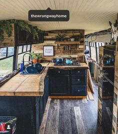 the interior of a mobile home kitchen with wood flooring and walls made out of pallet boards