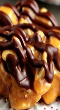 chocolate covered doughnuts sitting on top of a paper towel