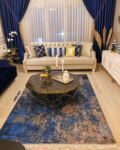 a living room filled with furniture and blue curtains