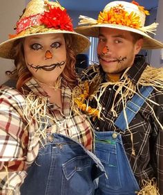 a man and woman dressed up as scarecrows