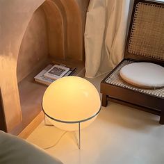 a chair and table in a room with a book on the floor next to it