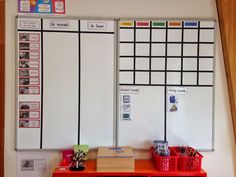 a whiteboard with several different types of writing on it next to a red desk