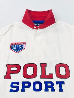 Sporty White Polo Shirt For Team Events, White Cotton Polo Shirt For Team Events, Sporty Polo Shirt For Sports Events, Sports Polo Collar Tops With Graphic Print, Sporty Polo T-shirt For Team Events, Sporty Polo Collar T-shirt For Team Events, Sporty Graphic Print Polo Shirt For Team Events, Team Spirit Cotton Polo Shirt For Sports Events, Sporty Polo Shirt For Sports Season