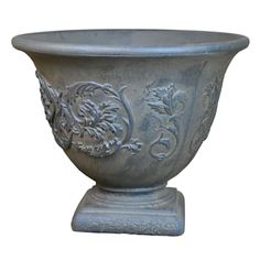 a large gray vase sitting on top of a stand