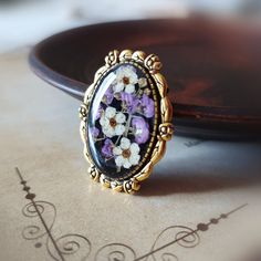 a close up of a ring with flowers on it