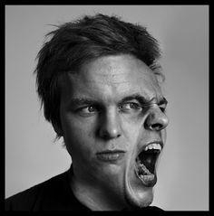 a man with his mouth open and an evil look on his face is shown in this black and white photo