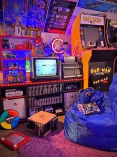 a room filled with lots of video game equipment and games on top of the shelves