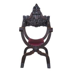 an ornate chair with a red seat