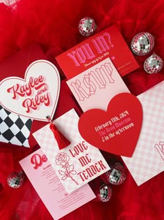 valentine's day cards and envelopes on red fabric with silver foiled decorations