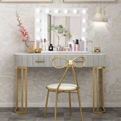 a dressing table with a mirror, stool and lights on it in front of a wall