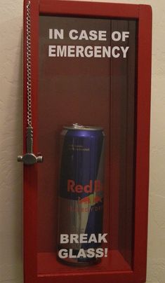 a can of red bull energy drink is in a case with chains hanging from it