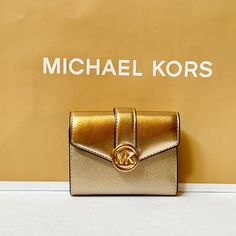 New With Tag Michael Kors Carmen Medium Flap Bifold Wallet Saffiano/Smooth Leather Pale Gold 100% Authentic Retail: $258.00 Plus Tax Gold Toned Hardware Mk Logo At Front Snap Closure 6 Credit Cards Slots 2 Inside (Side Credit Card Slots) Paper Bill Compartment Coin Zipper Pocket Custom Fabric Lining 7.5"(W)X 3.5"(H)X 1.1"(D) Very Clean, Smoke-Free And Pet-Free Environment. Mk Logo, Pale Gold, Bifold Wallet, Michael Kors Bag, Credit Cards, Smooth Leather, Snap Closure, Card Slots, Zipper Pocket