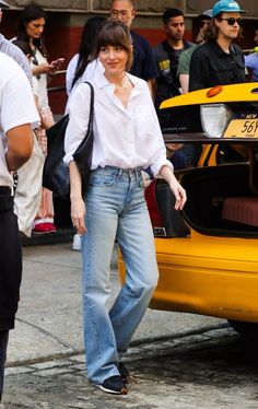 Look of the Day for May 9, 2024 features Dakota Johnson in a white button-up shirt, bootcut jeans, and Nike sneakers. Shop similar pieces at Amazon, Nordstrom, and J.Crew.#WinterFashion #StyleGuide2024 #TrendyOutfits #WomensFashion #WinterStyle #FashionInspo #WinterWardrobe #FashionTrends #WinterLooks