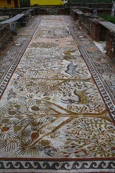 an old mosaic floor in the middle of a courtyard