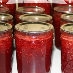 jars filled with red liquid sitting on top of a table