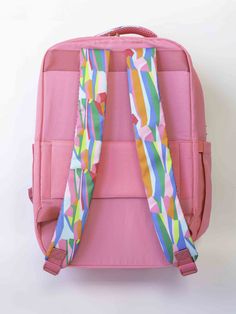 The Travel Backpack is a blend of style and practicality designed to enhance your travel experience. It features a solid color exterior adorned with vibrant patterns on the handles and straps. Its size is the perfect balance between spaciousness and convenience, making it an ideal companion for your travels! Details: 13"W x 16.5"H x 8"D Patterned handle and straps Two main large pockets Two side pockets One front pocket Luggage sleeve with zipper pocket Polyester material Gold hardware Square Backpack With Adjustable Strap For Travel, Versatile Laptop Backpack For Trip, Nylon Luggage With Adjustable Strap For Daily Use, Rectangular Nylon Luggage With Adjustable Strap, Rectangular Laptop Bag For Commuting And Back To School, Rectangular Commuter Bags With Adjustable Straps, Versatile Luggage With Adjustable Strap For Daily Use, Rectangular Commuting Bags With Adjustable Straps, Pink Travel Accessories With Luggage Sleeve For Everyday Use