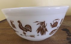 a white bowl sitting on top of a wooden table