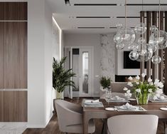 a dining room table and chairs with white flowers in vases on the centerpiece