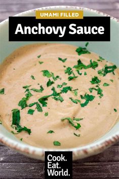 anchovy sauce in a white bowl with green garnish on the side