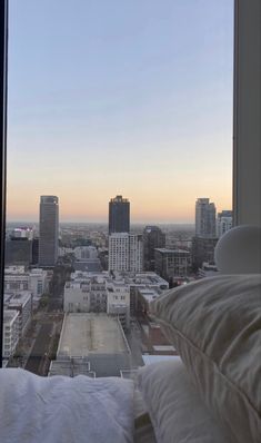 a window view of the city skyline from a hotel room