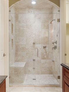 a walk in shower sitting inside of a bathroom