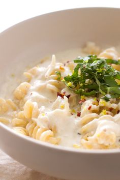 a white bowl filled with macaroni and cheese