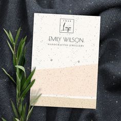 a close up of a piece of paper on top of a blanket with plants in front of it