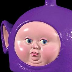 a close up of a purple object with a face on it's head and blue eyes