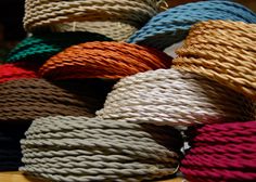 many different colors of rope are on the table and there is no image here to provide a caption for