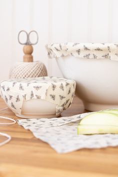 an apple slice is sitting on the table next to a bowl and other kitchen utensils